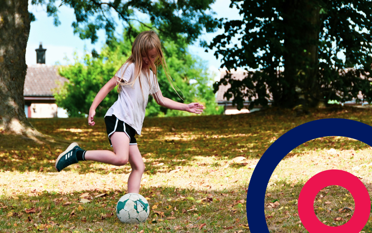 Young girl playing football in her garden with the Coordinate logo in the bottom right